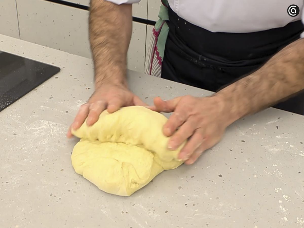 Amasa, estira y forma dos hogazas enroscando y dando vuelta a la masa