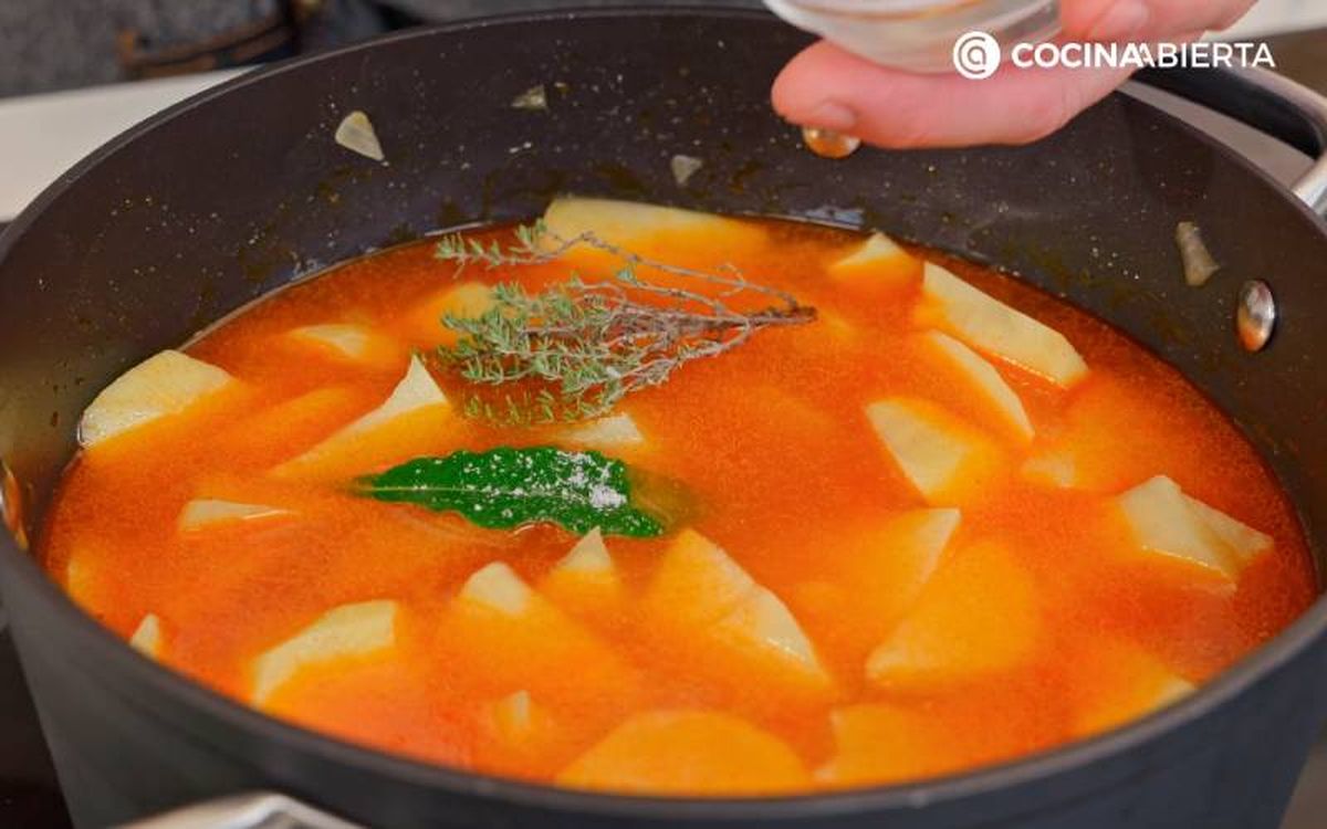 Añade caldo, especias y sal a la cazuela y guisa las patatas
