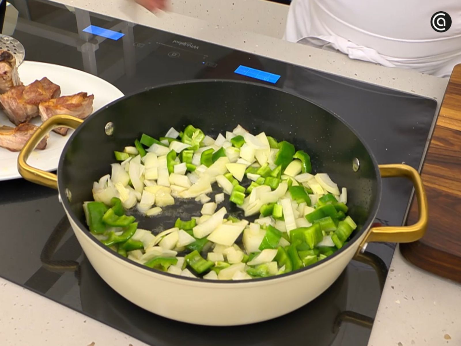 La cebolla y el pimiento se pochan lentamente hasta quedar tiernos y ligeramente dorados.