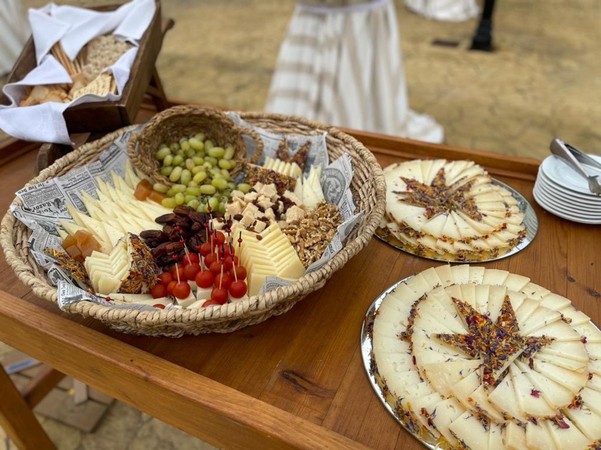 El queso con pétalos se convierte en protagonista de cualquier tabla gourmet, acompañado de fruta, pan y frutos secos.