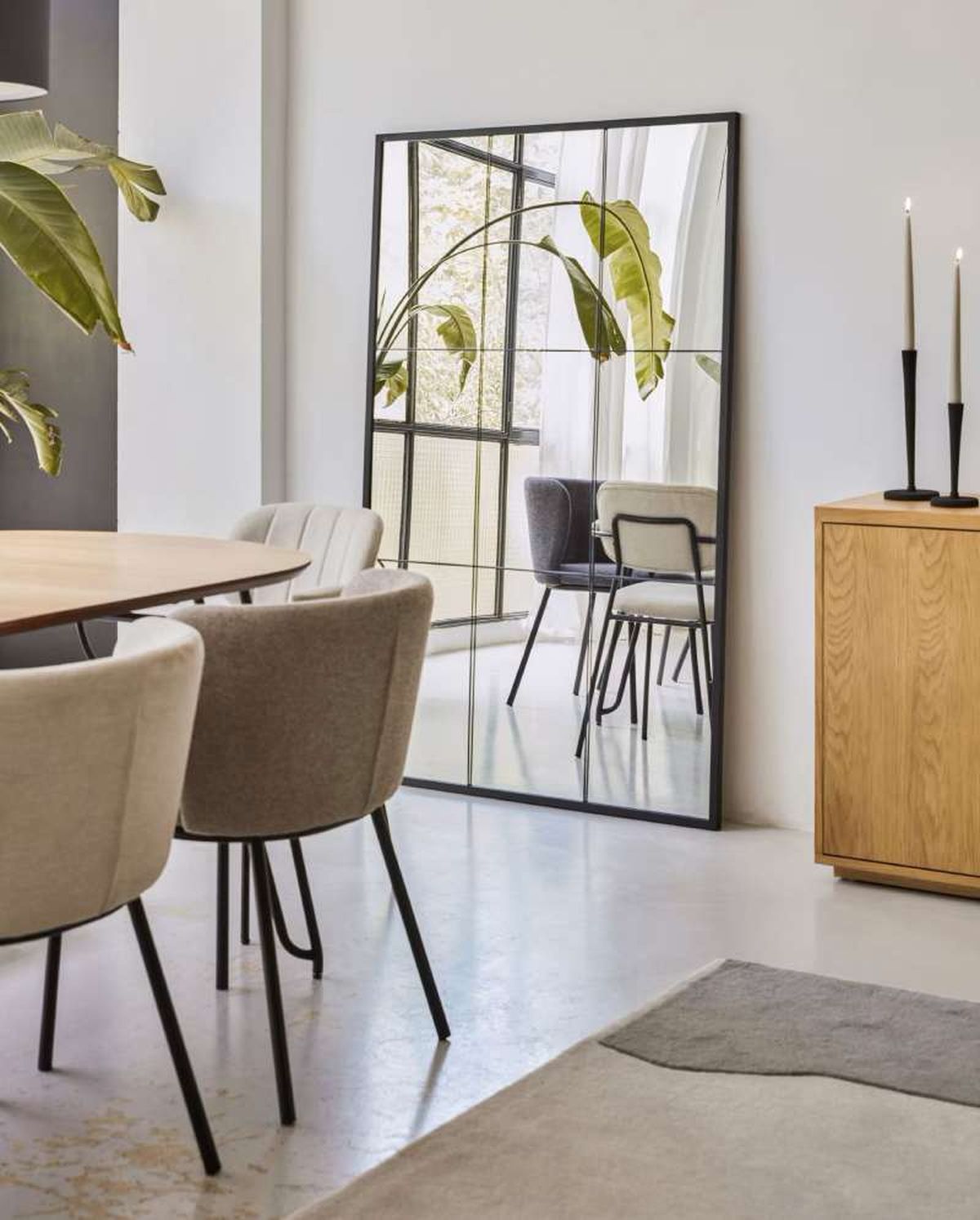 Comedor con espejo grande para atraer la abundancia según el feng shui.