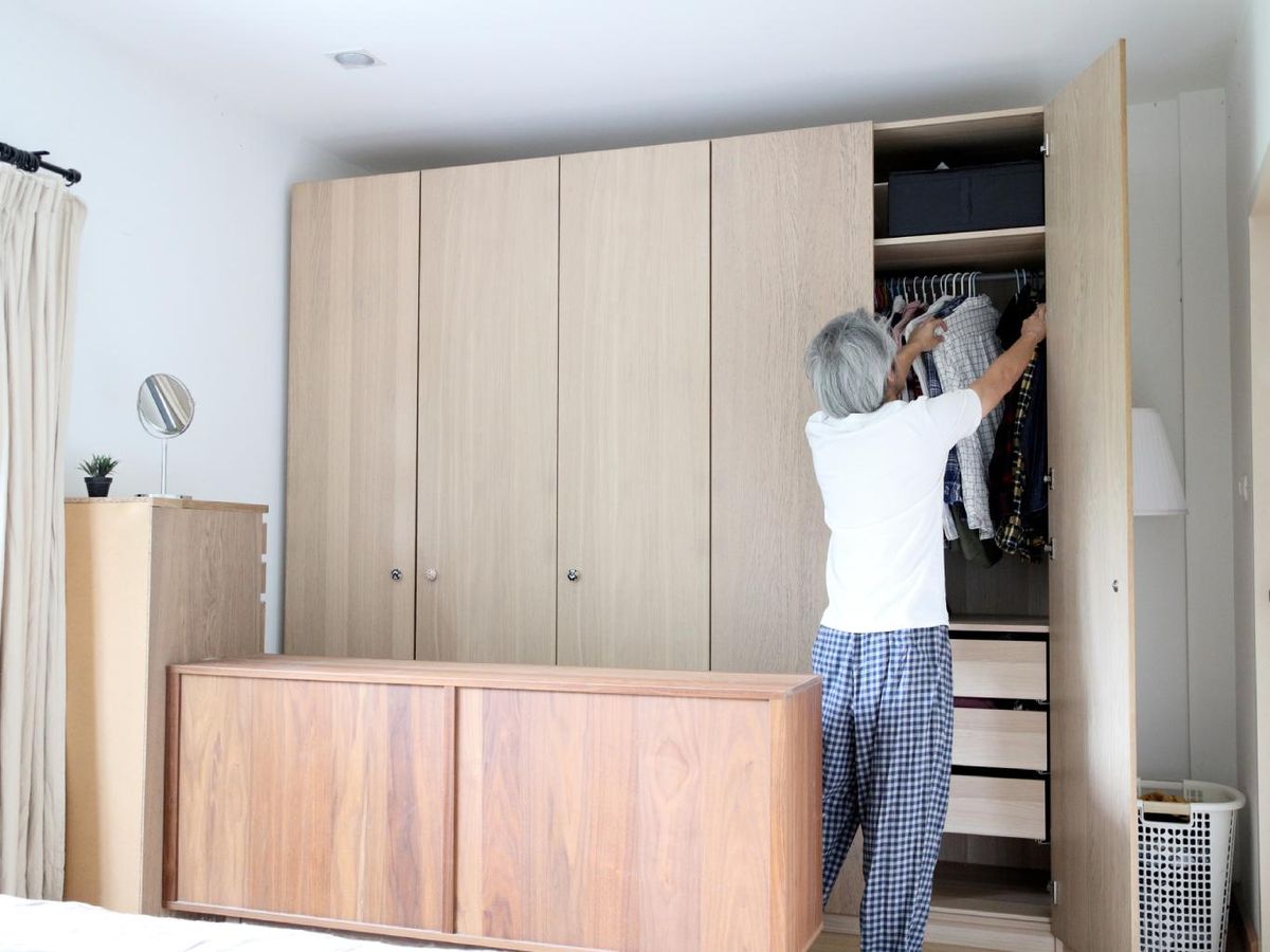 Hombre organizando armario empotrado.