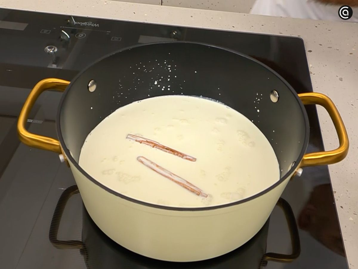 Calienta la leche con la nata, la canela y el licor