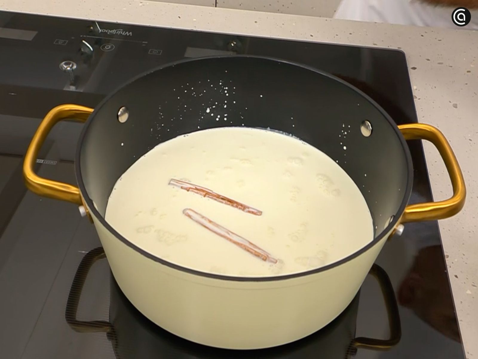 Calienta la leche con la nata, la canela y el licor