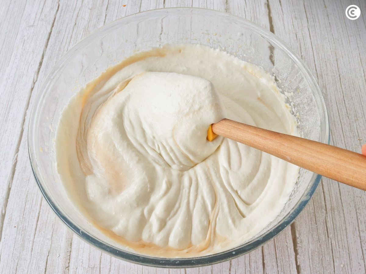Añadir la nata montada a la mezcla para la tarta de melocotón