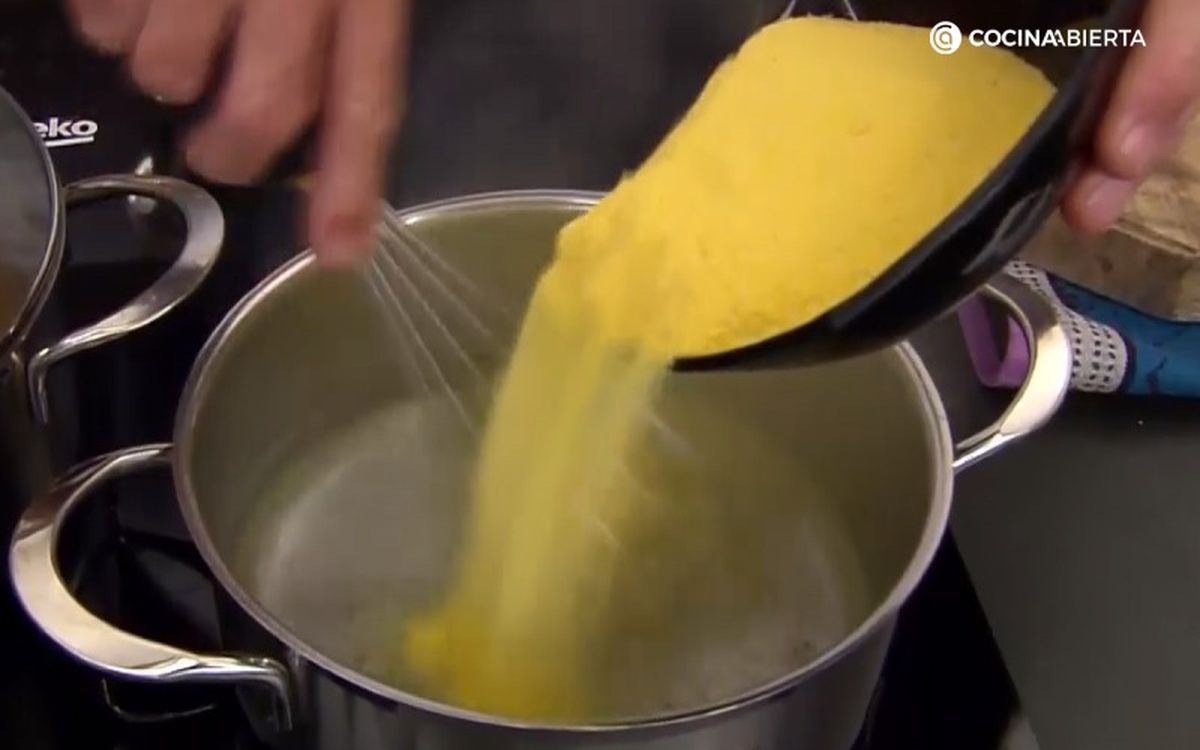Echa poco a poco la polenta en agua para cocinarla sin dejar de remover