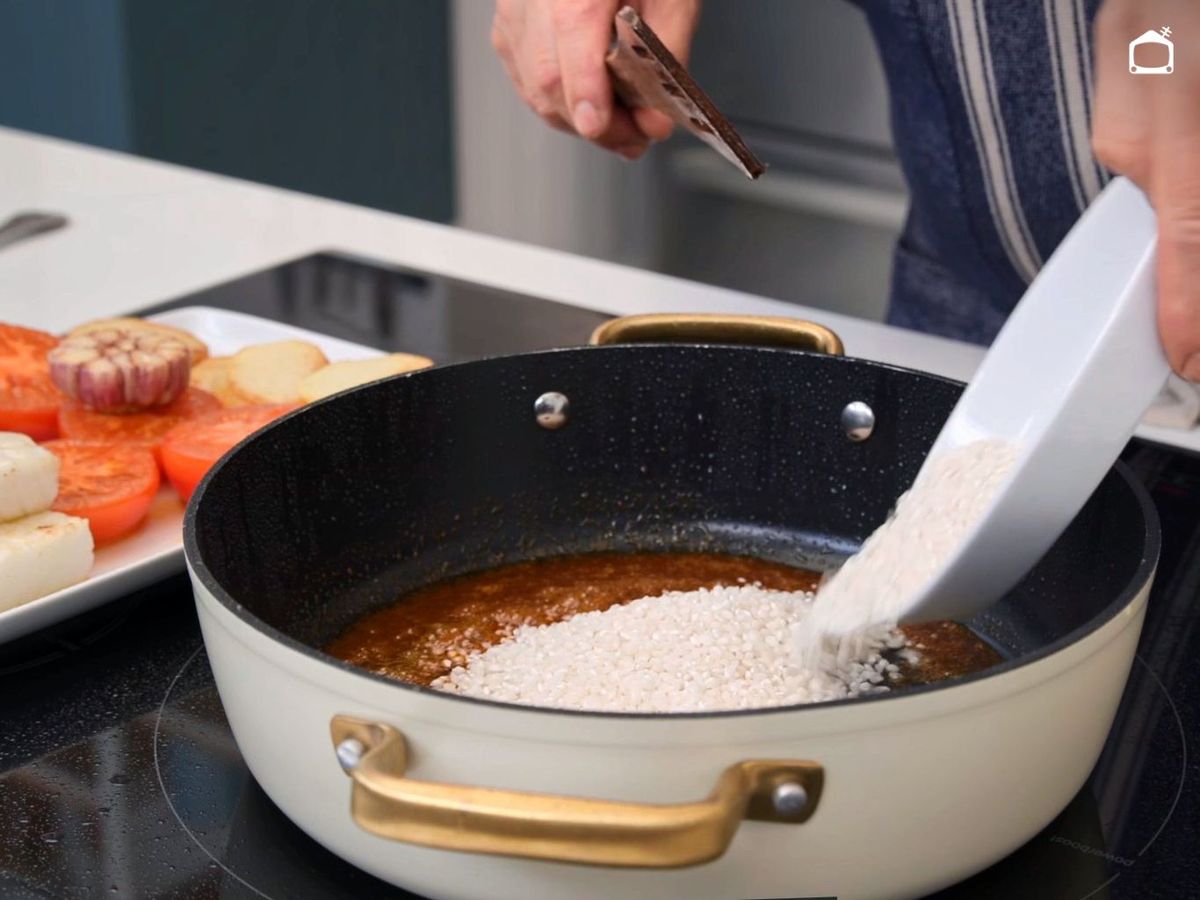 Agrega el arroz a la cazuela para hacerlo al horno con bacalao