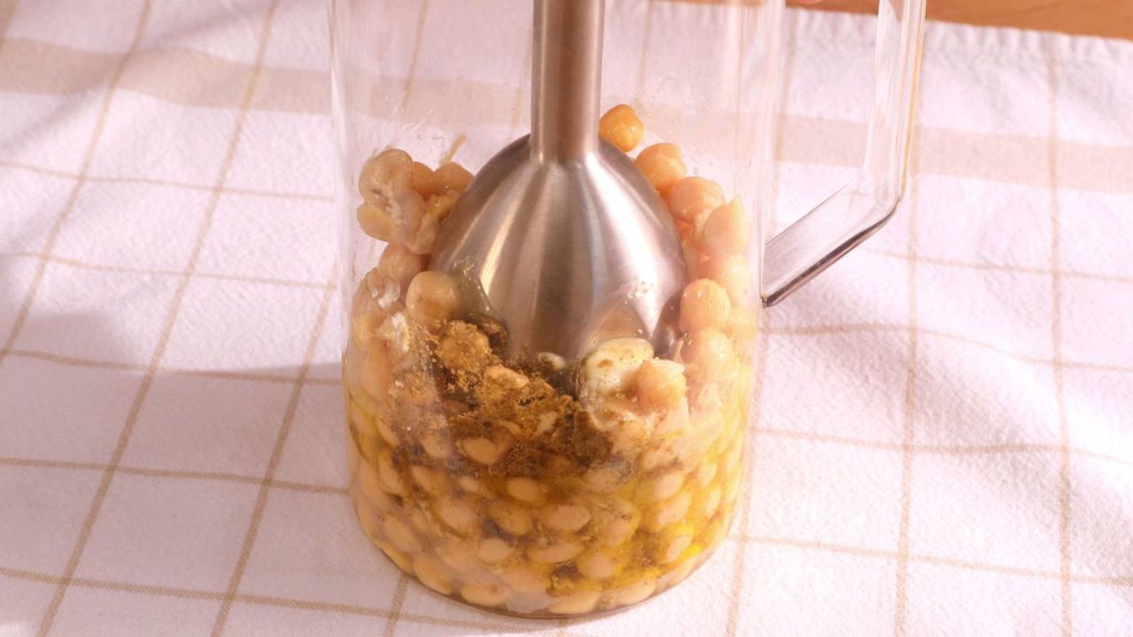 Utiliza la batidora para triturar los ingredientes hasta conseguir un hummus cremoso y homogéneo Utiliza la batidora para triturar los ingredientes hasta conseguir un hummus cremoso y homogéneo