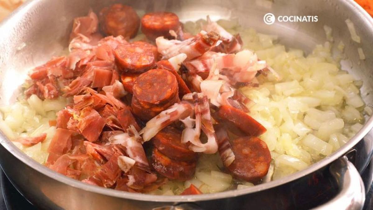 Pochamos la cebolla y añadimos los embutidos