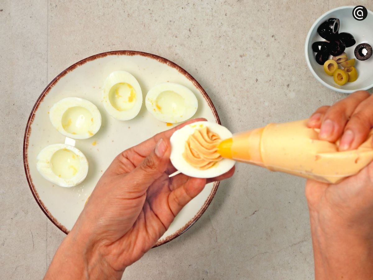 Pon la mezcla en una manga pastelera y rellena las claras