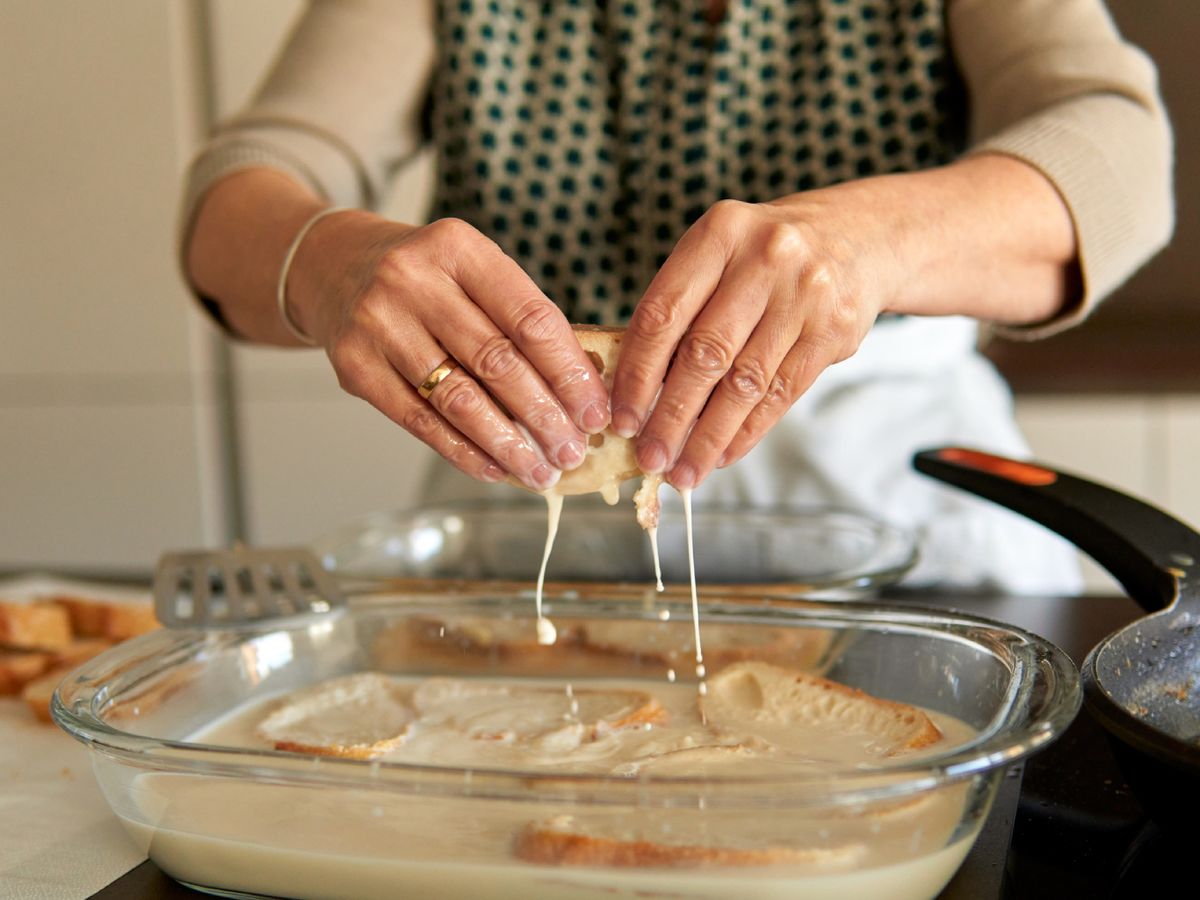 El pan empapado en leche antes de pasar por el huevo y la sartén, un gesto repetido en muchas cocinas.
