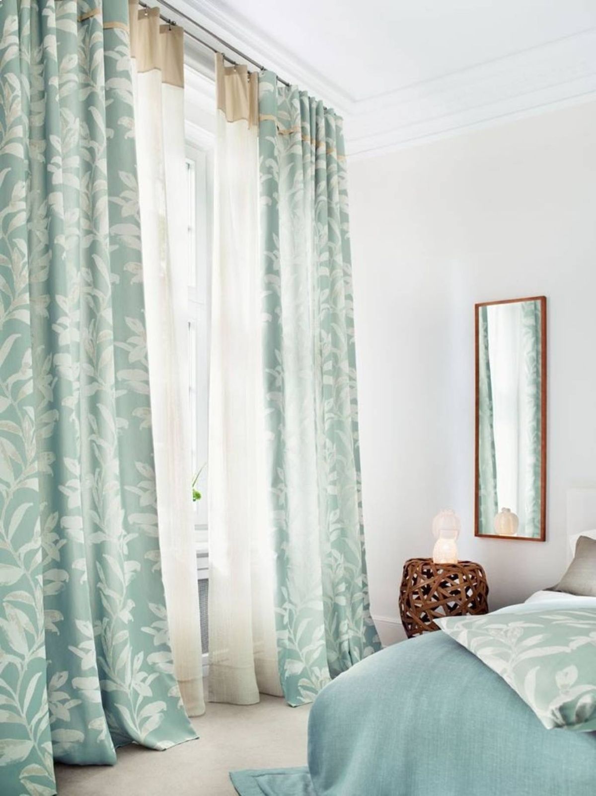 Un salón moderno con visillos blancos y cortinas pesadas que aportan elegancia.