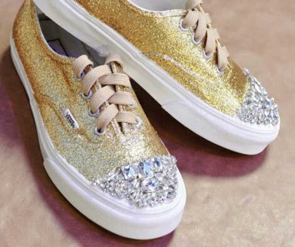 Zapatillas Vans decoradas con purpurina dorada y piedras decorativas.