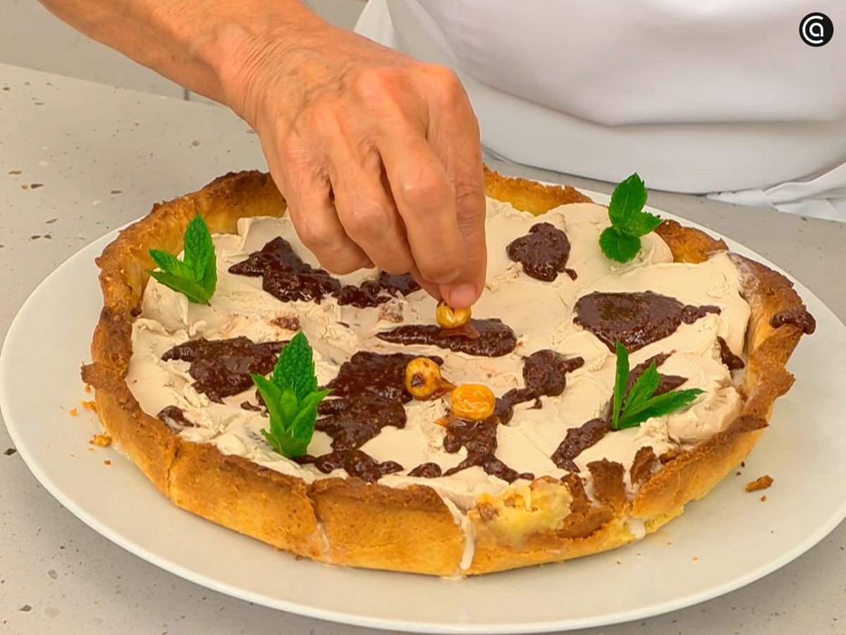 Decora la tarta helada con hojas de menta y avellanas caramelizadas