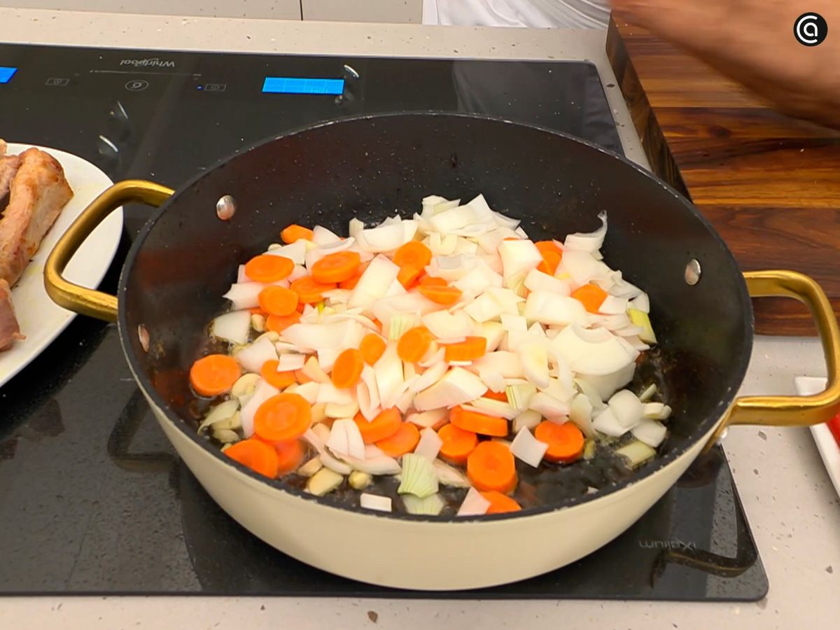 Rehoga en la tartera la cebolla con las zanahorias hasta que tomen colo