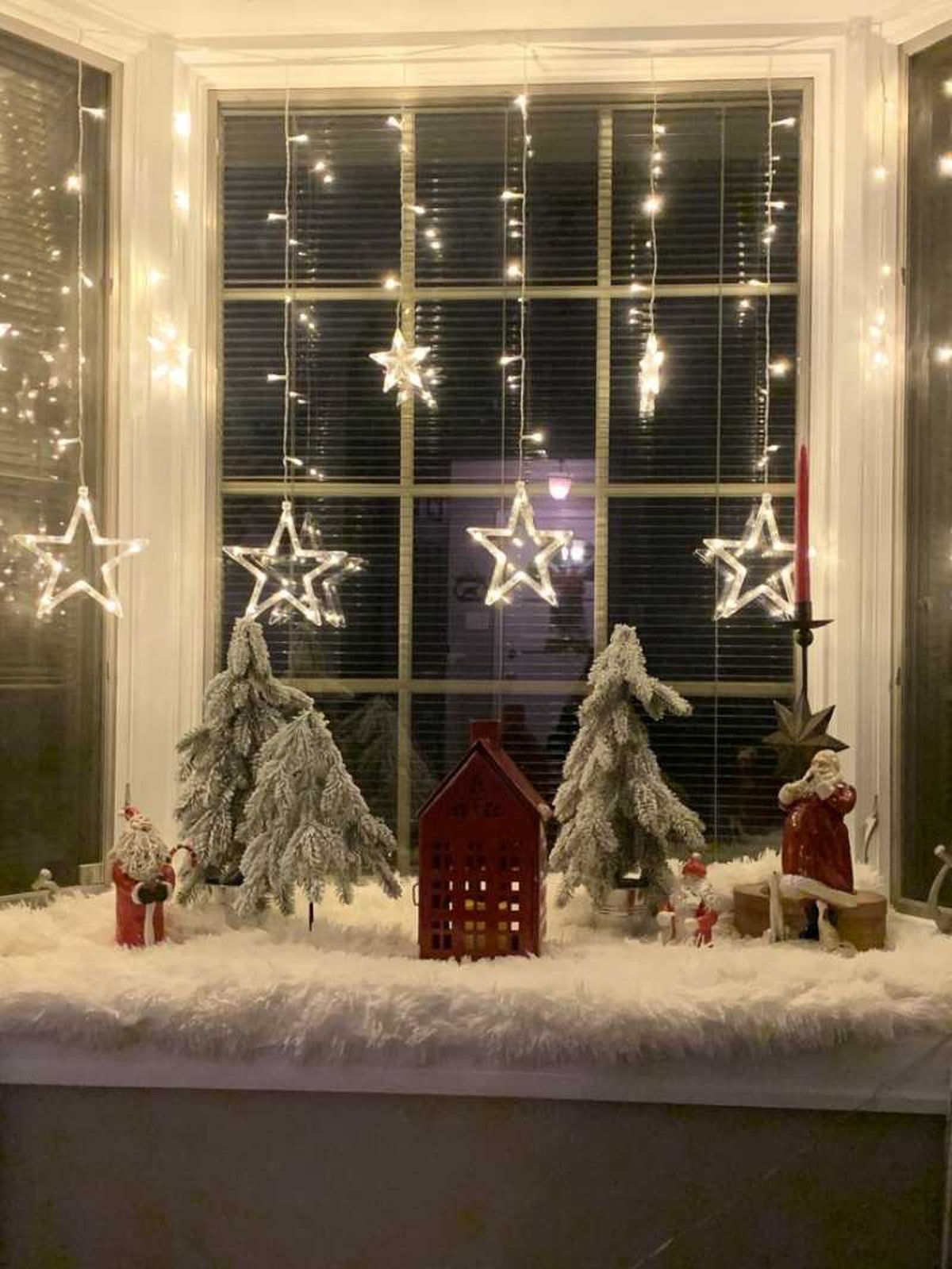 Alféizar decorado con un pueblo de Navidad.