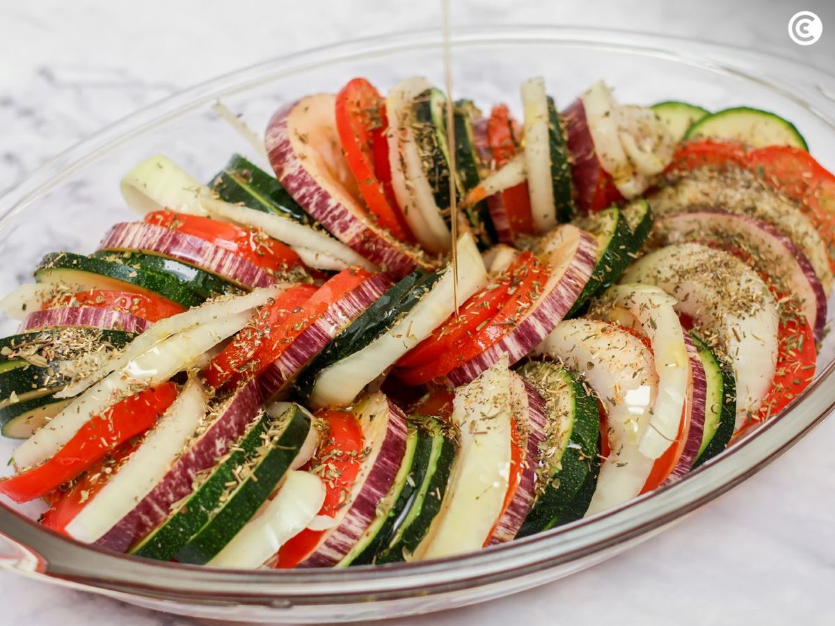 Añadir aceite y especias al tian de verduras