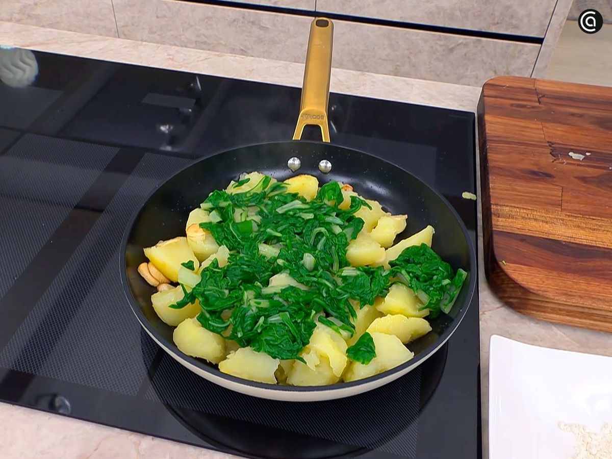 Cocinar las hojas con las patatas y el ajo para las acelgas a la vasca
