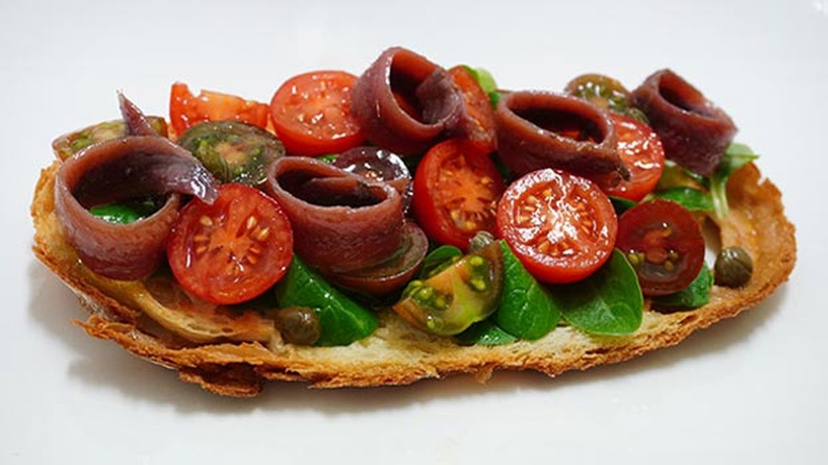 Tosta de anchoas con tomate y canónigos