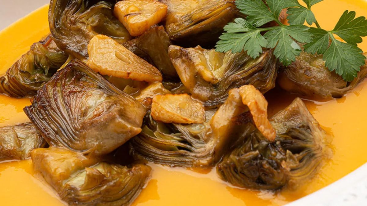 Alcachofas salteadas sobre crema de calabaza, una combinación de otoño con sabor de huerta.