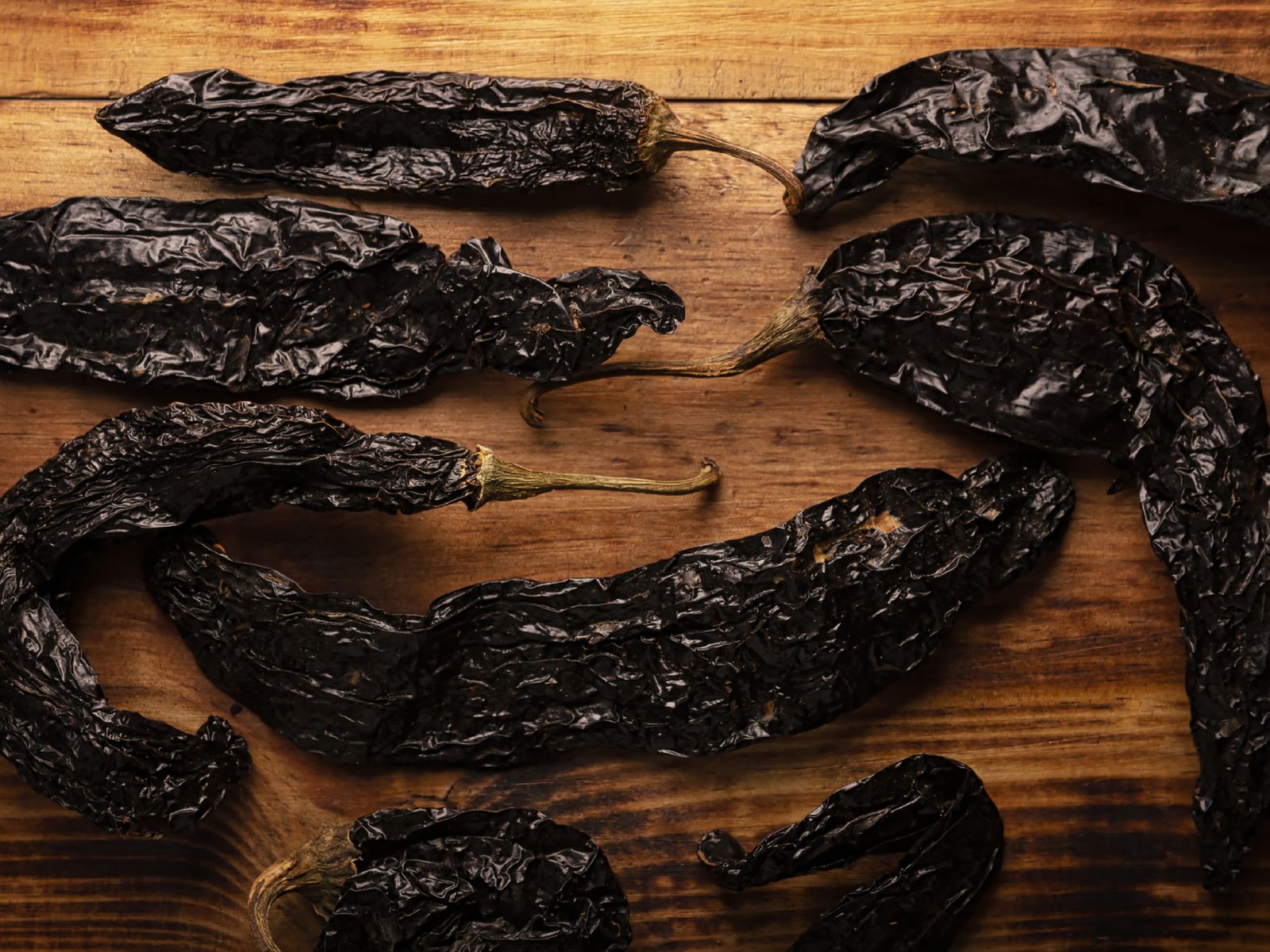 Seco, oscuro y alargado, con sabor ahumado y notas dulces, muy usado en moles y salsas mexicanas.