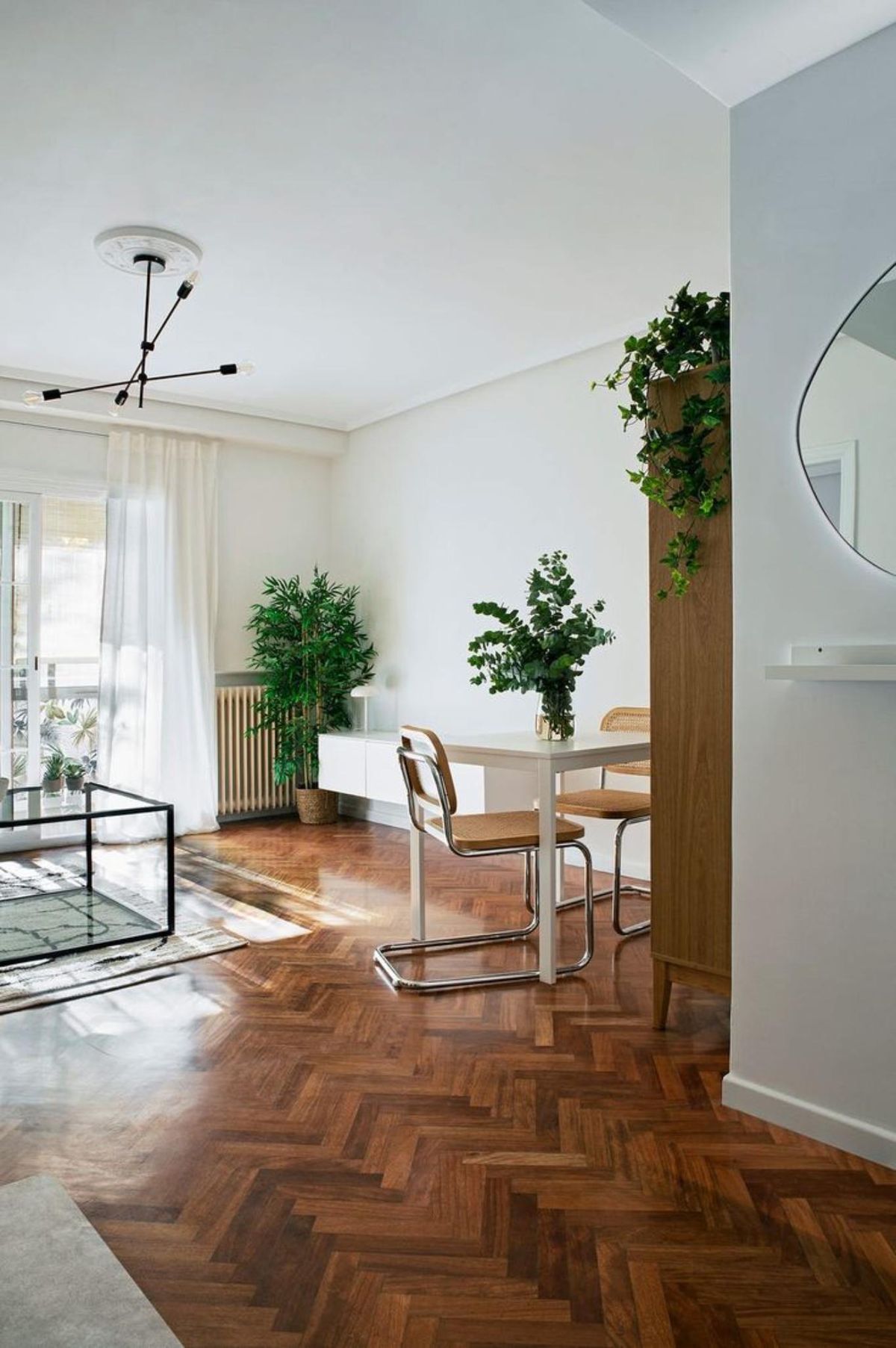 Salón elegante con suelo de nogal decorado en blanco.