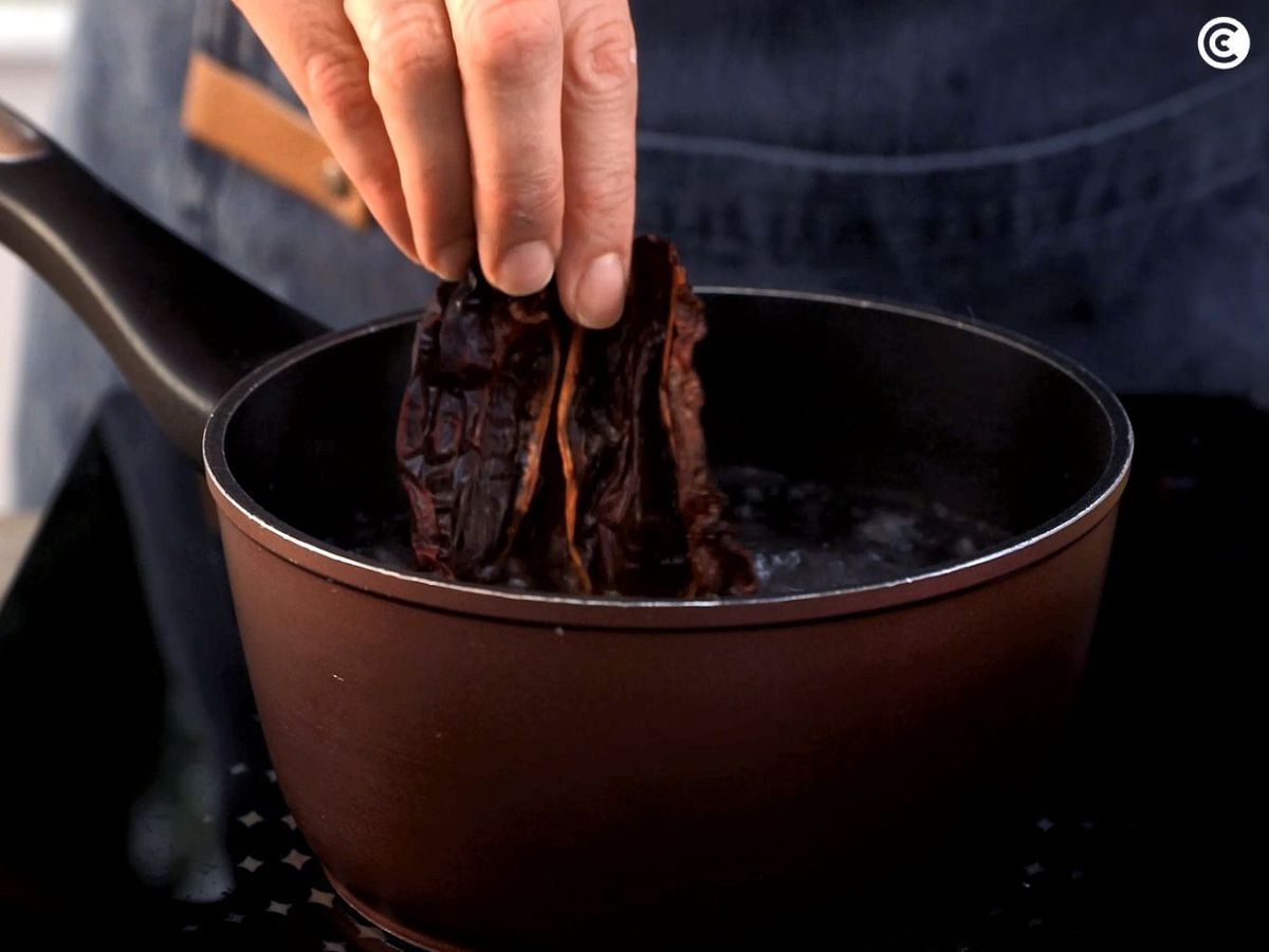 Cuece los pimientos choriceros para hacer la salsa vizcaína