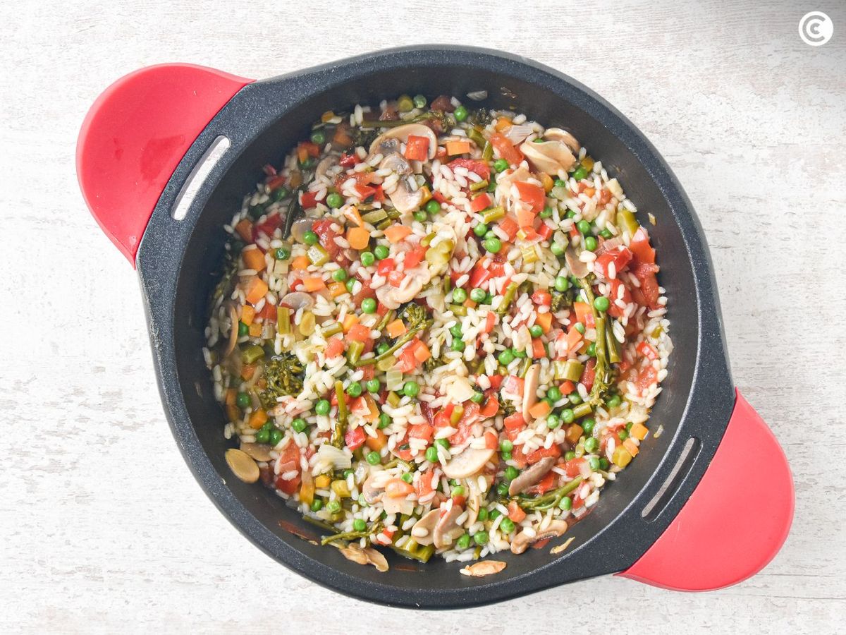 Agregar el caldo poco a poco para cocer el risotto de verduras