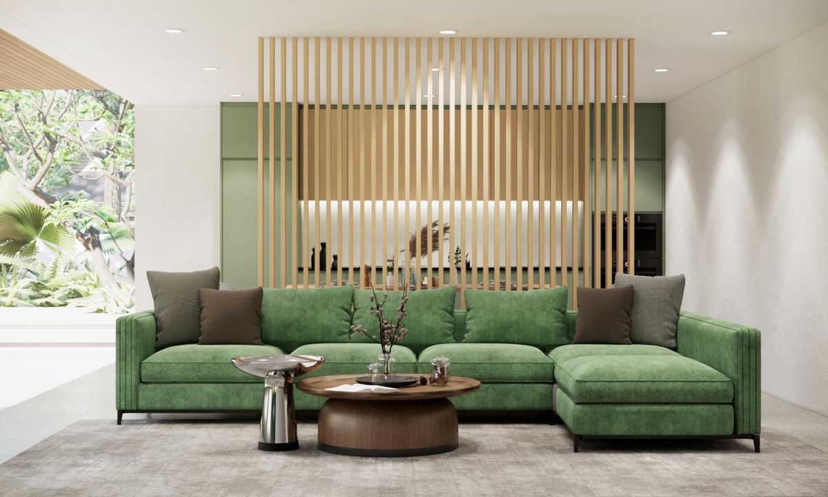 Salón de estilo nórdico con sofá verde combinado con complementos en tonos tierra.