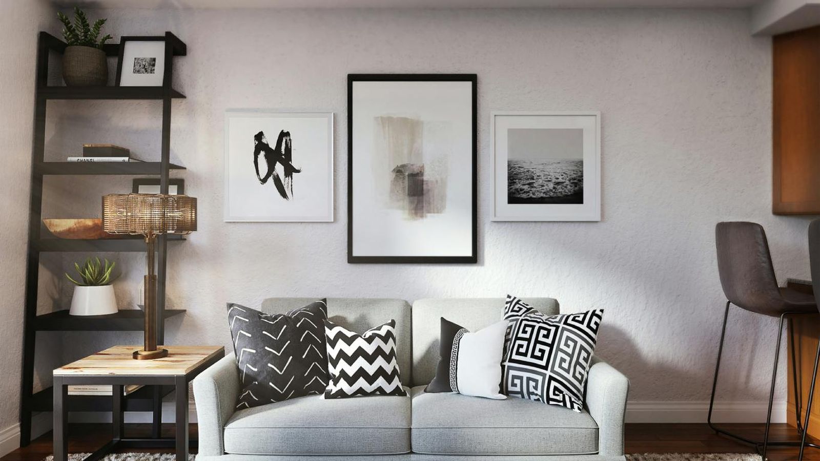 Salón con una pared grande decorada con cuadros en blanco y negro.