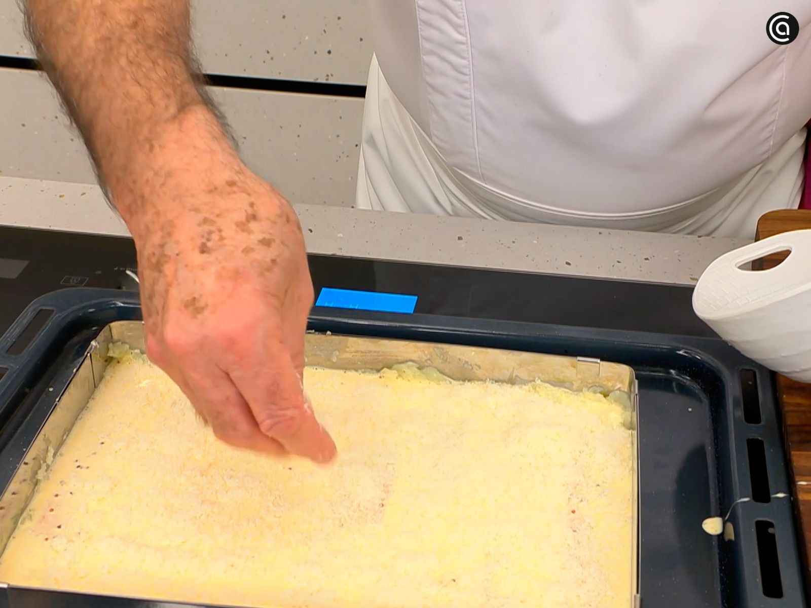 Cubre las salchichas con la mezcla de huevos, nata y mostaza, añade queso por encima y hornea