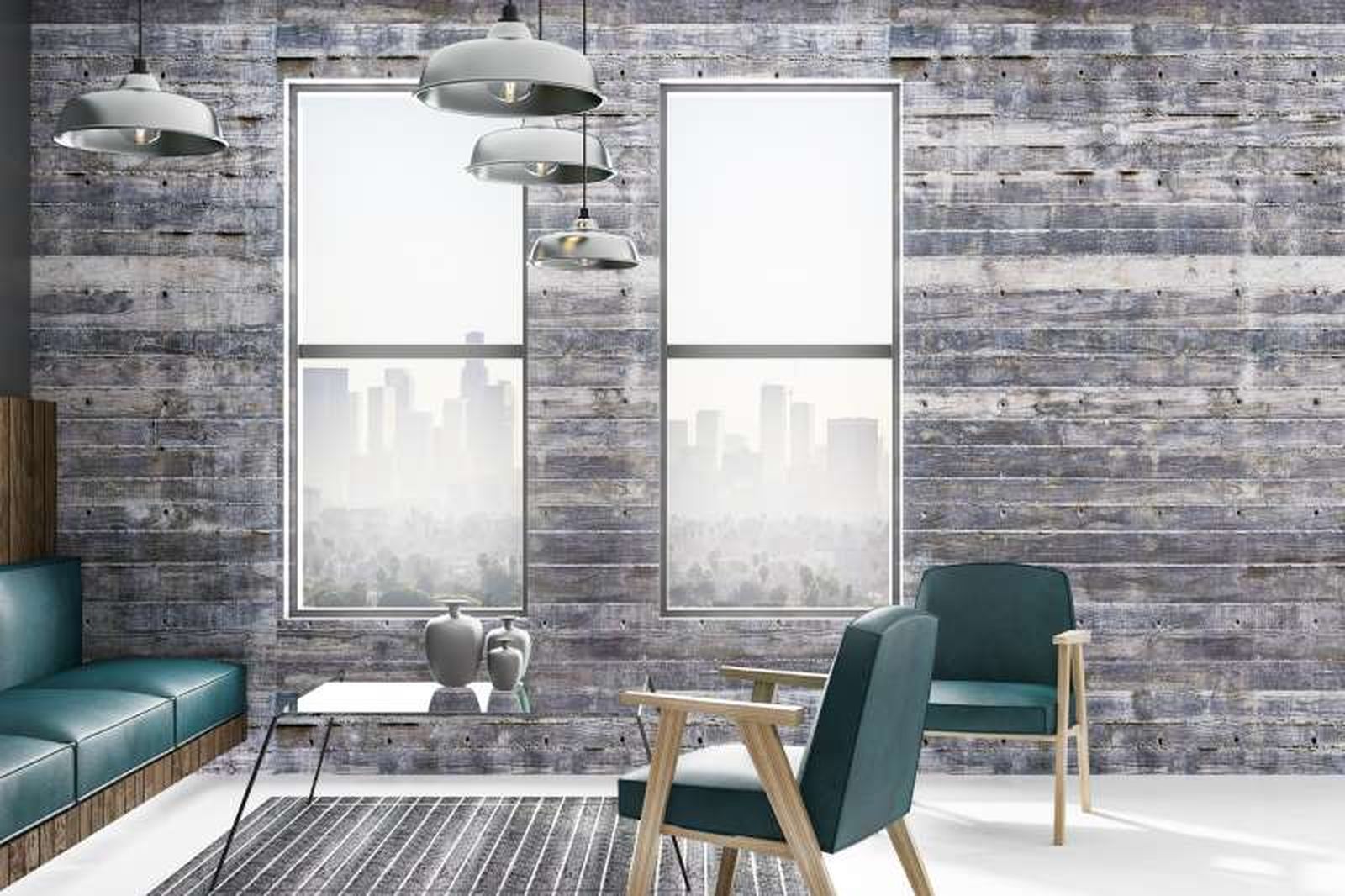 Salón de estilo industrial con mesa de cristal con patas de metal.