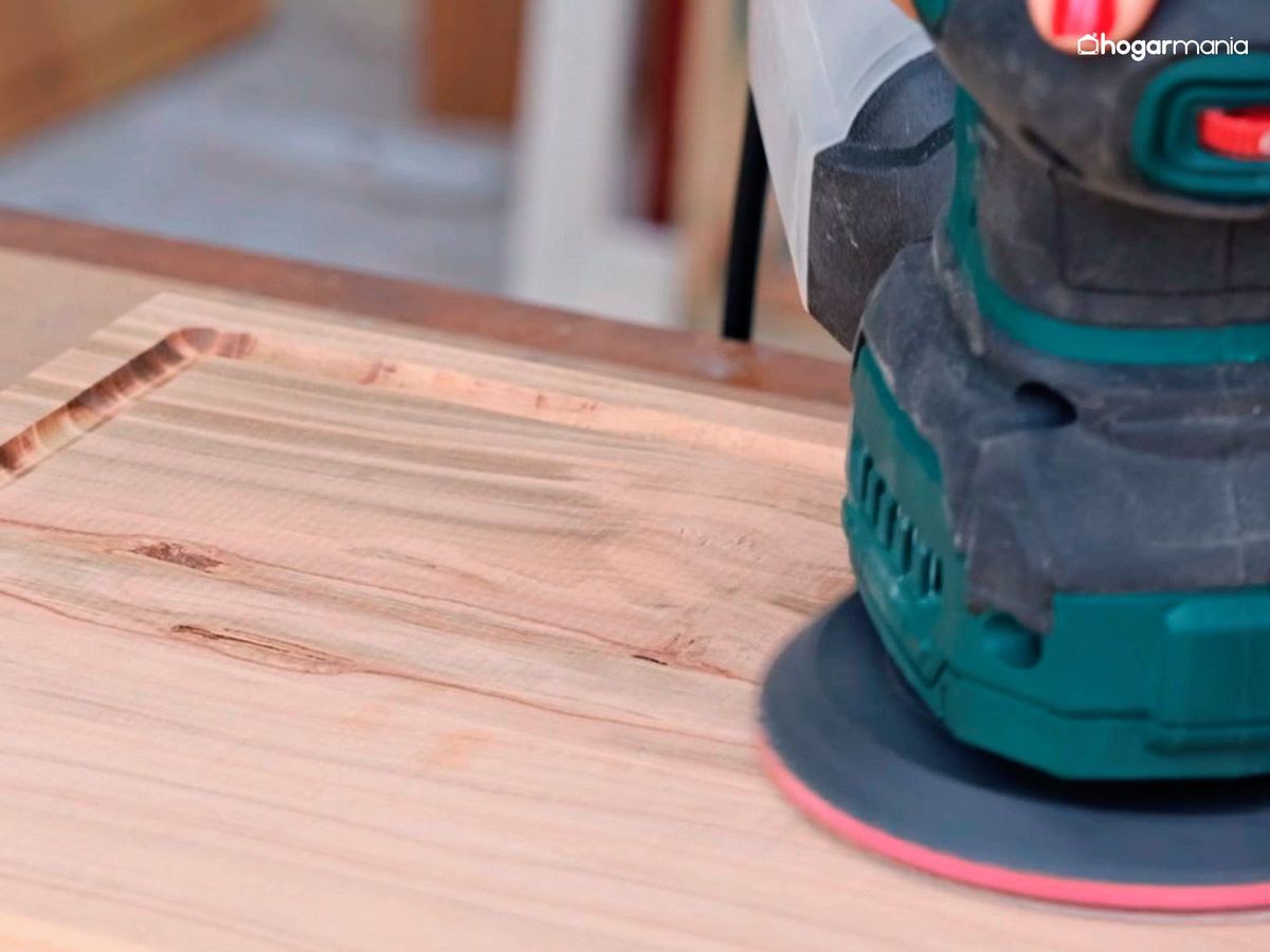 Lija la tabla de cortar de madera