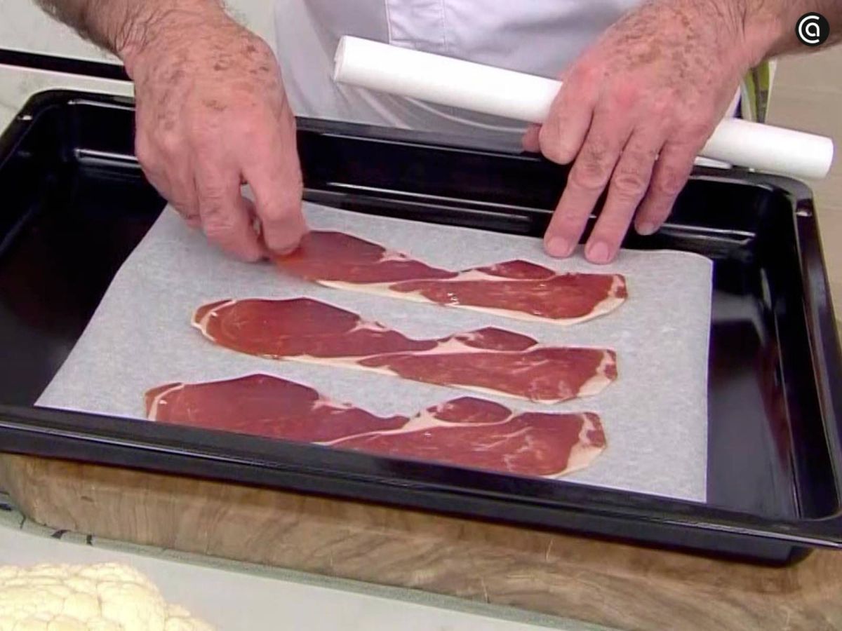 Sobre papel de horno, extiende las lonchas de jamón serrano
