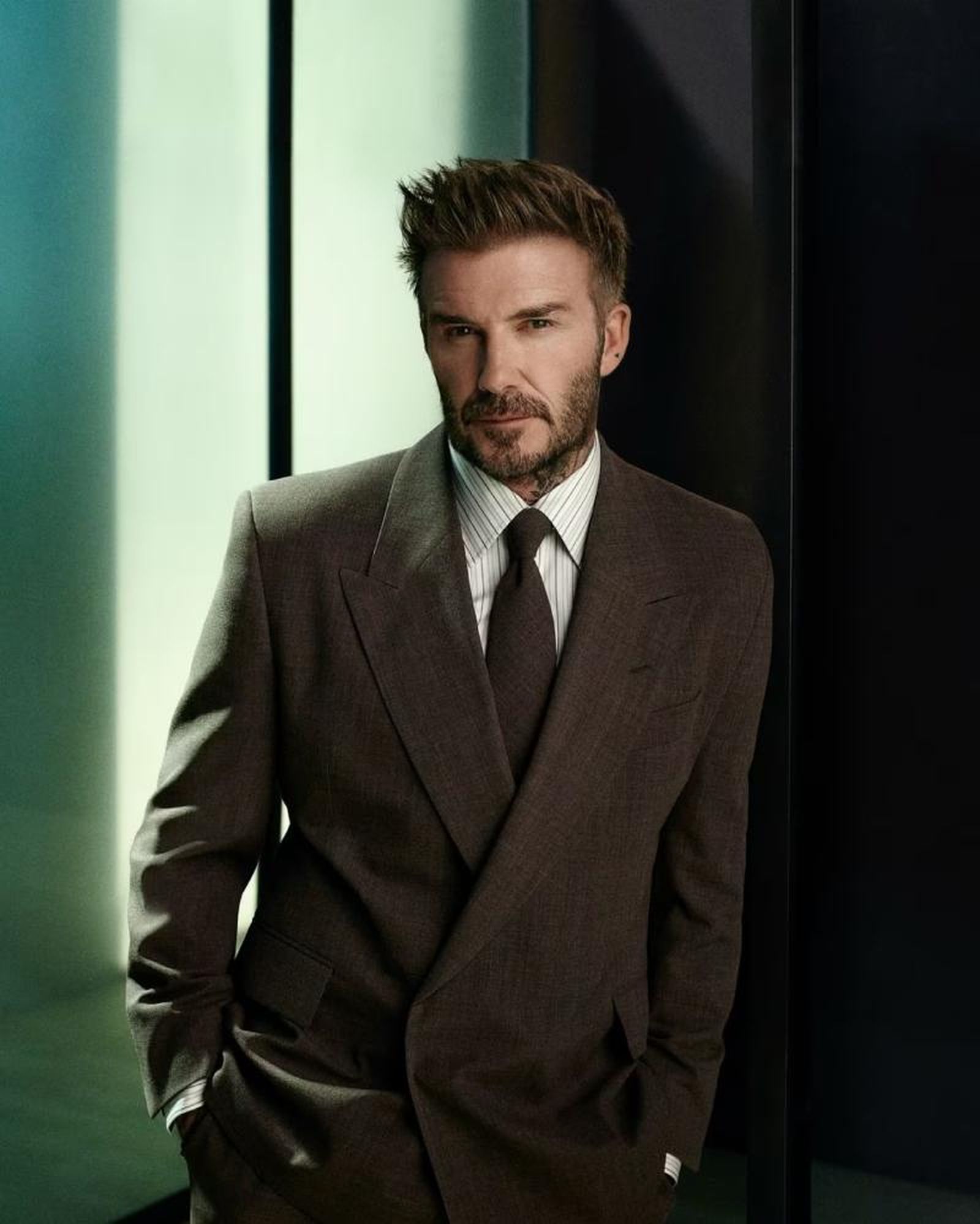 David Beckham posando con traje y corbata marrón de Boss David Beckham posando con traje y corbata marrón de Boss